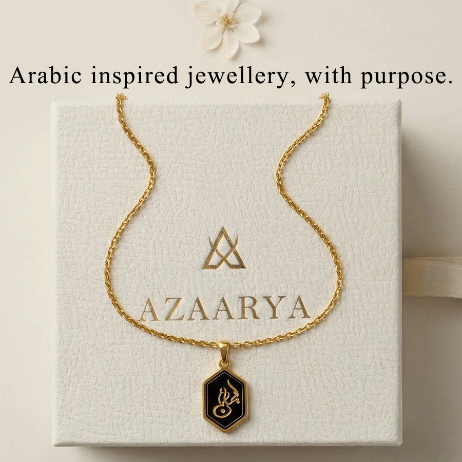 Gold necklace on a box with 'AZAARIA' branding, featuring Arabic text.