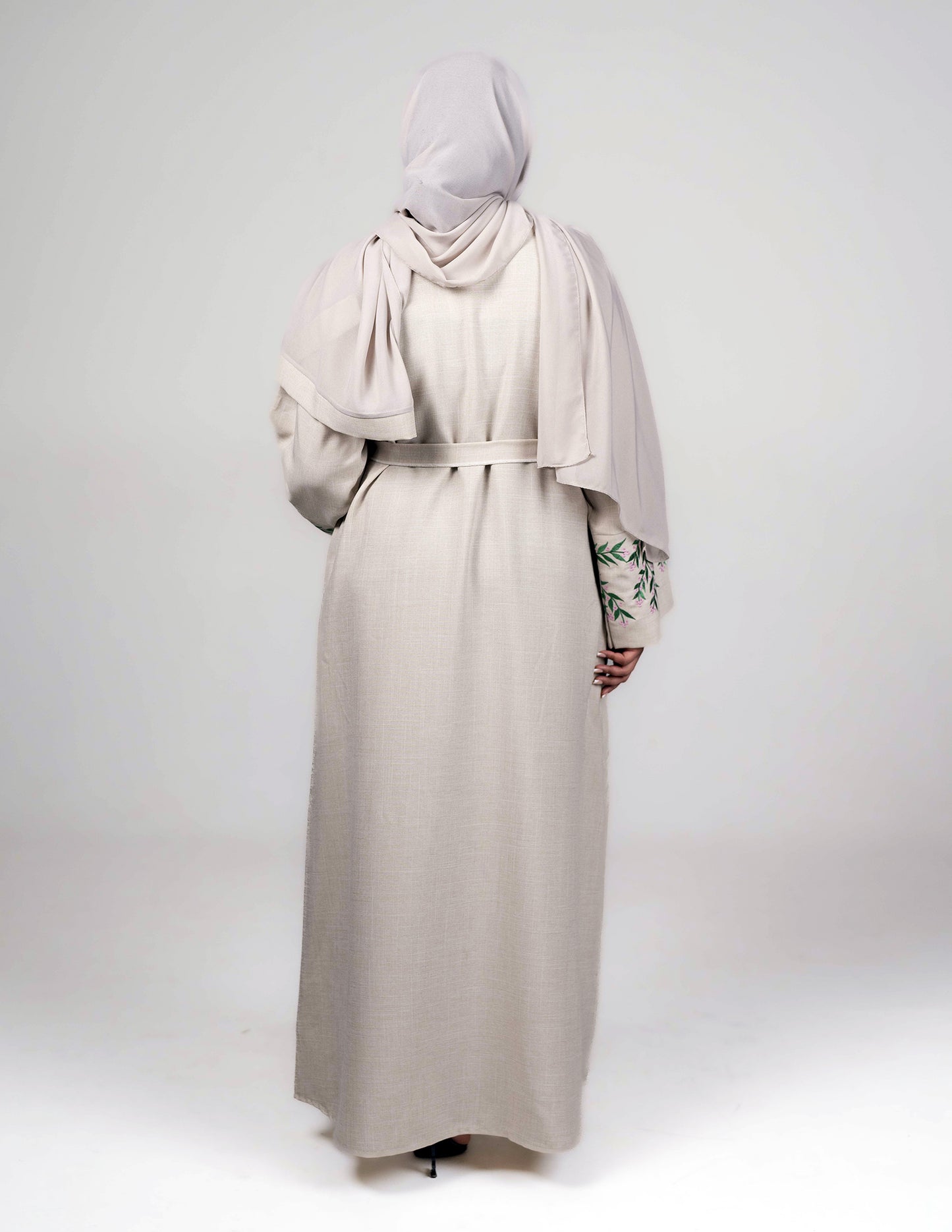 Beige linen closed abaya showing full back view and design details.