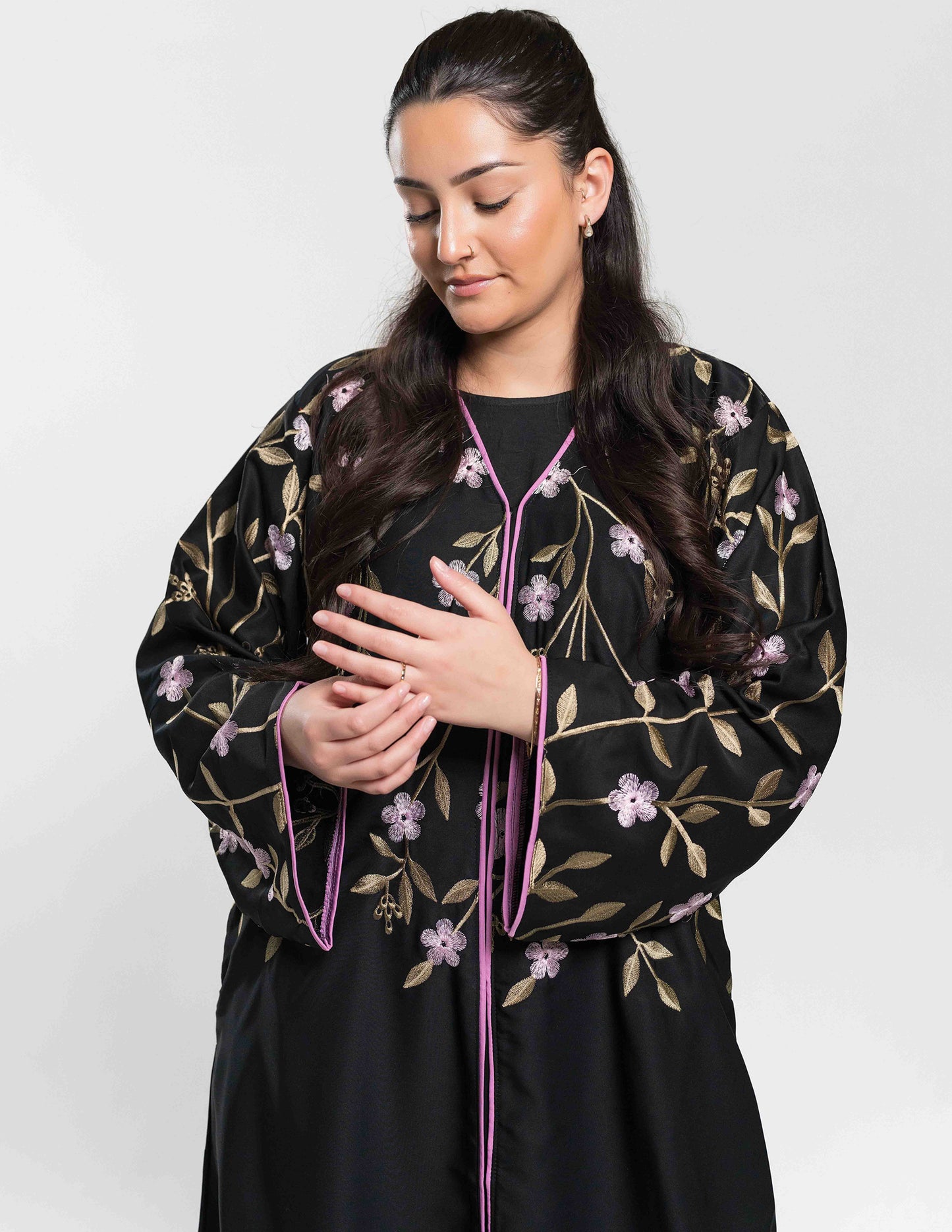 Close-up of a black monsoon open floral abaya highlighting intricate embroidery and fabric details.