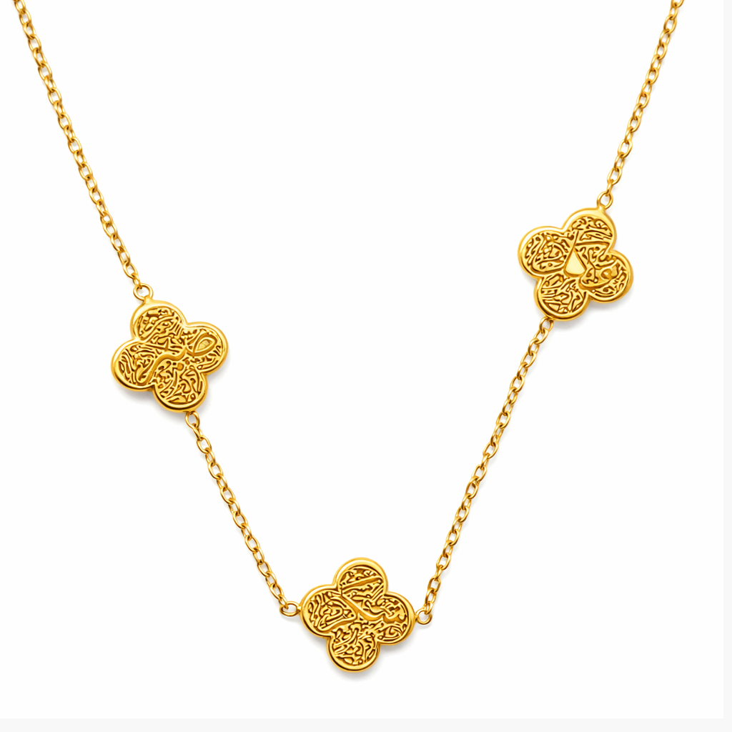 Gold necklace with clover-shaped pendants saying sabr shukr tawakkul