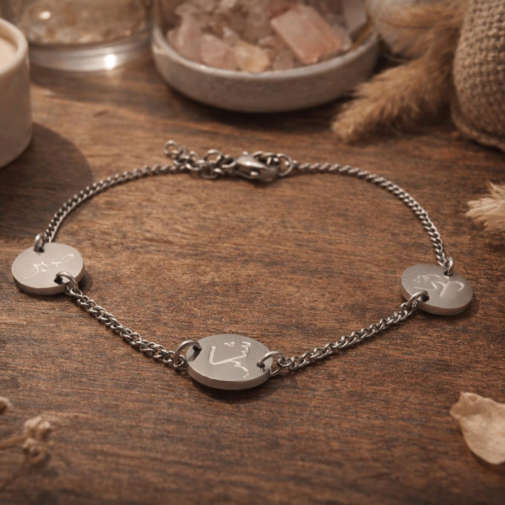 sabr shukr & tawakkul silver bracelet on wooden table close up
