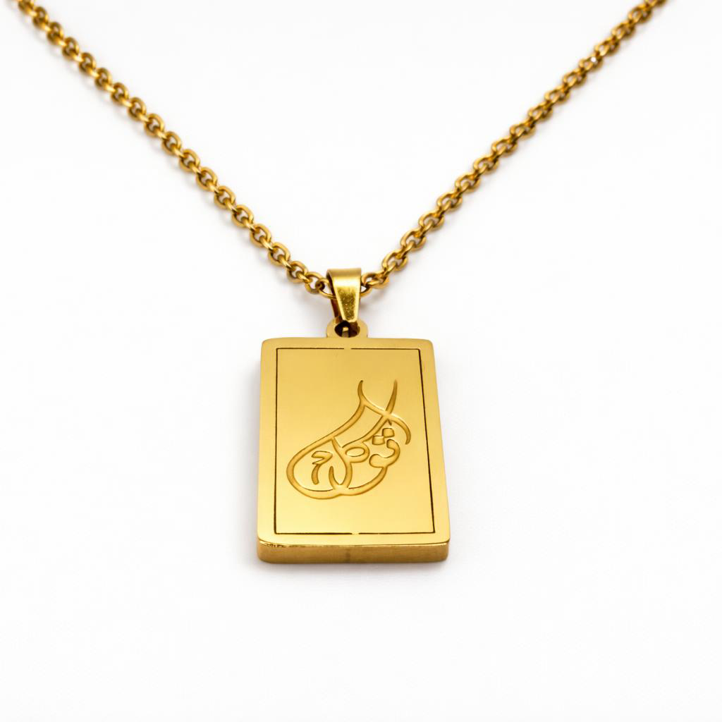 Gold tawakkul necklace with a rectangular pendant on a white background