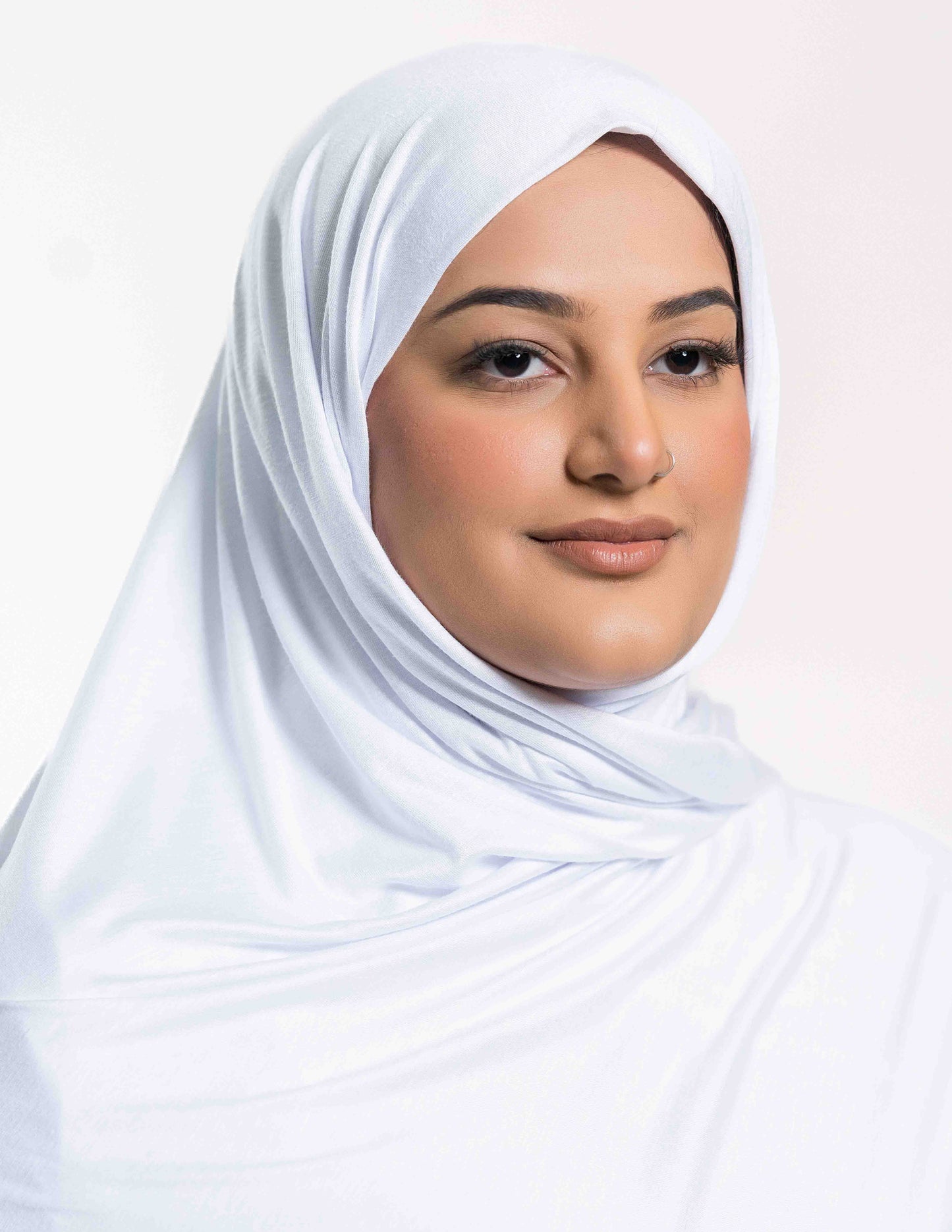 A woman wearing a white jersey hijab.